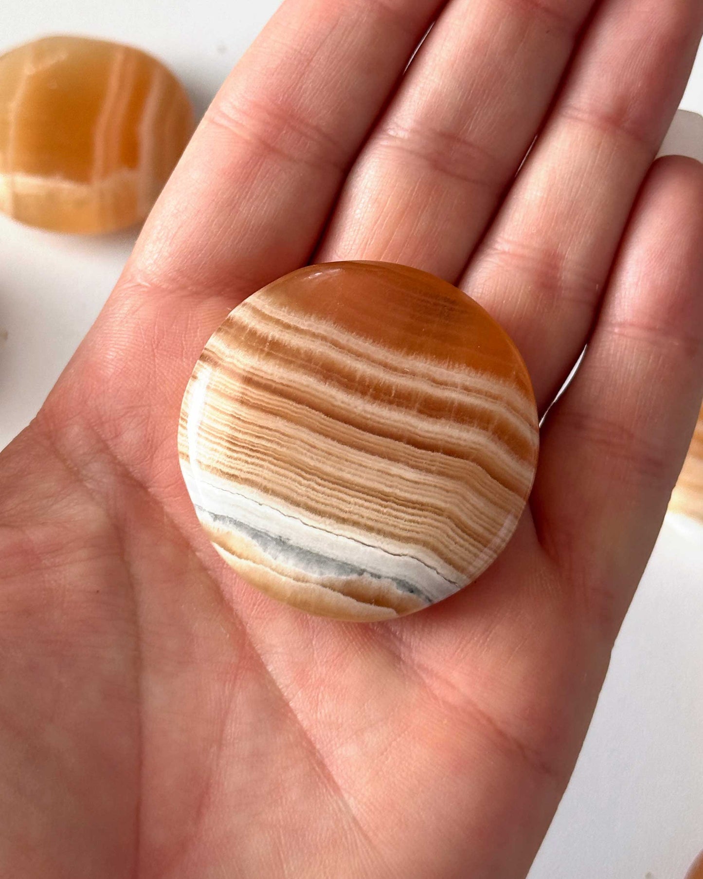 Banded Honey Calcite Round Palm Stone