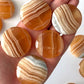 Banded Honey Calcite Round Palm Stone