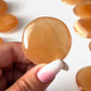 Honey Calcite Round Palm Stone